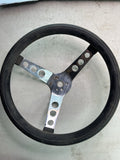 Approx. 11" diameter Drilled aluminum-style spokes Black grip (shows wear) Class0